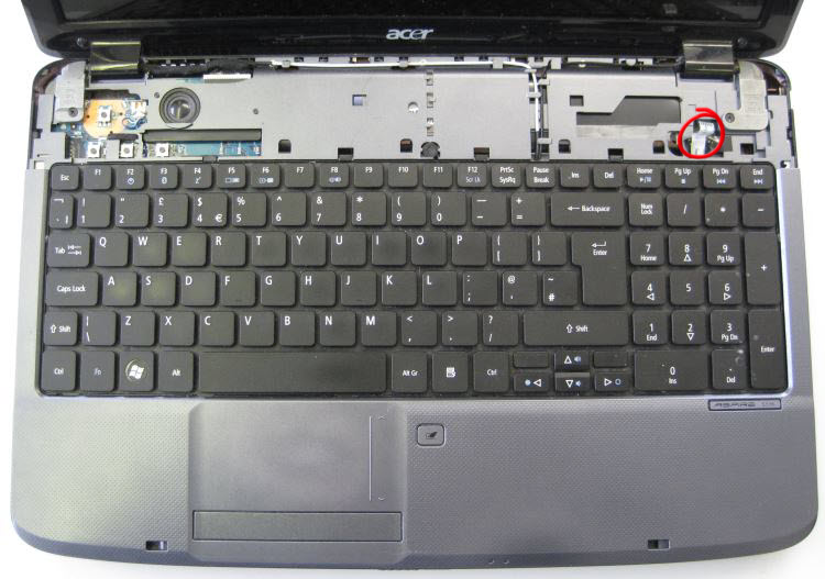 Acer Aspire with top panel above keyboard removed. Note ribbon cable circled, this is attached to the top panel