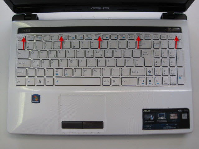 Turn the laptop over and remove the keyboard. The keyboard is held in by 5 retaining clips that need pushing back in the direction shown.