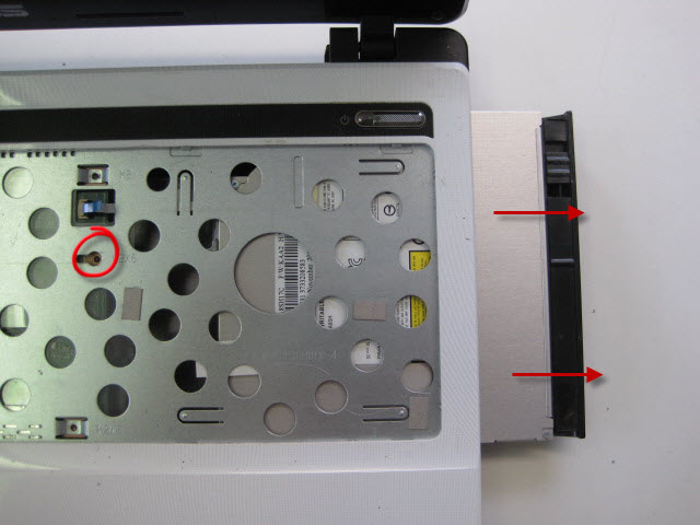 Remove the screw circled and remove the DVD drive as shown.