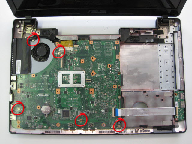 The top cover should now separate from the base revealing the motherboard below. Remove the screws circled. They are holding the motherboard in place. Note that one is different from the others.