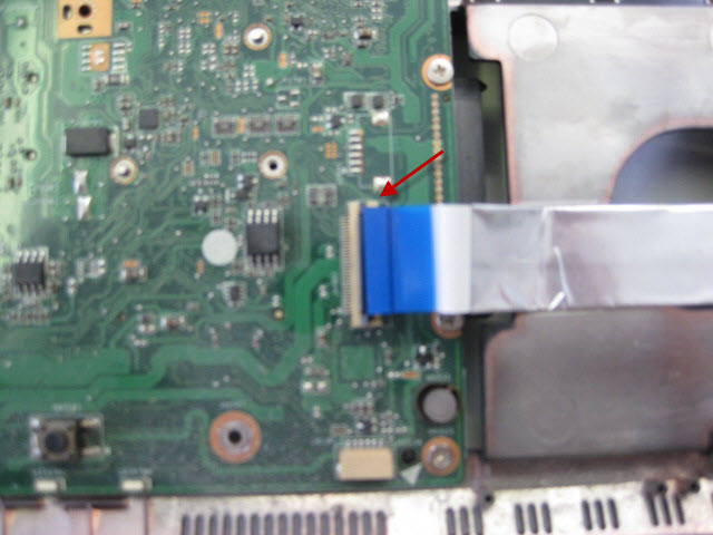 Detach the ribbon from the motherboard by lifting the brown clip.
