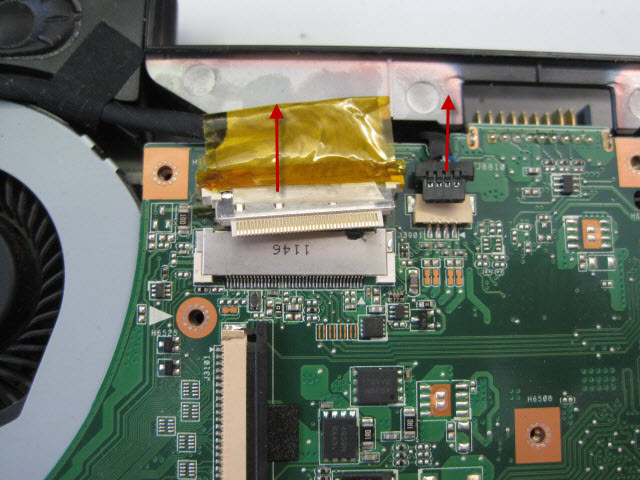 Gently pull the monitor and speaker cables out of the motherboard in the direction show. There are no retaining clips but there is tape holding the monitor cable in place.