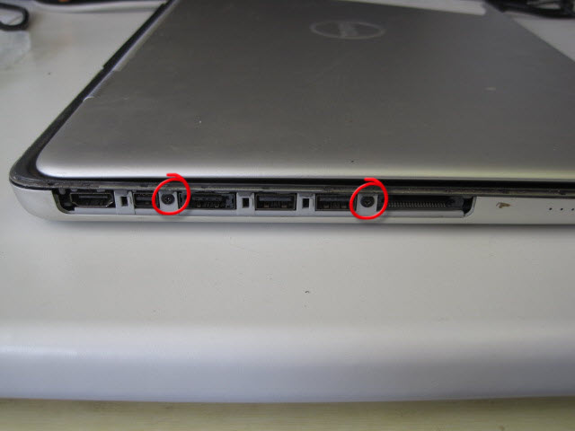 Remove the two hidden screws behind the panel.